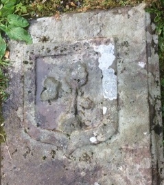 Stone on left clearly showing a sword with a crown crossed by a tree. Photo by Peter Lawrie