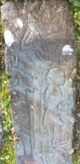 Stone over the grave of Rob Roy - showing a sword, a crude human figure and something above. Photo Peter Lawrie